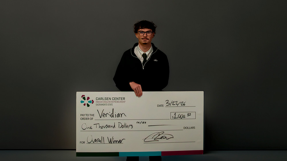 Team Veridian holding the overall winner check